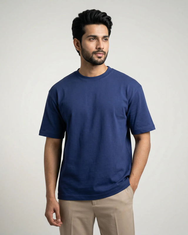 Man wearing a royal blue t-shirt against a plain background