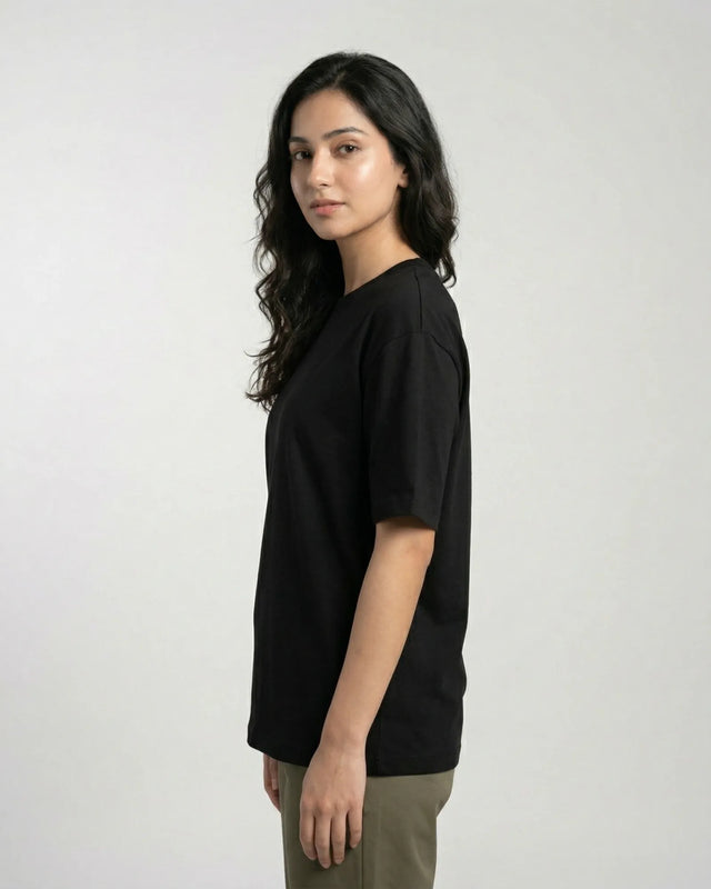 Woman wearing a black t-shirt against a plain background