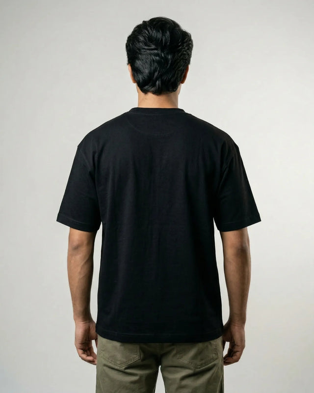 Man wearing a black t-shirt against a plain background