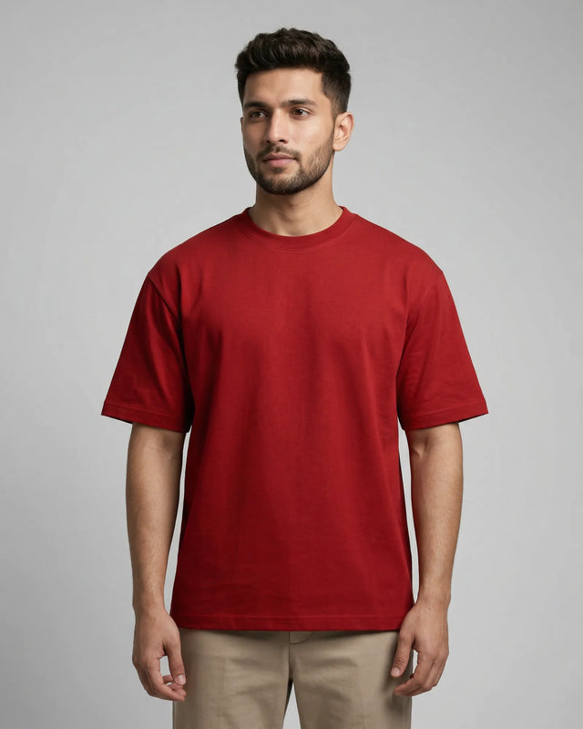 Man wearing a red t-shirt against a gray background