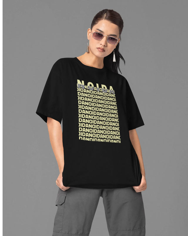 Person wearing a black t-shirt with text on a gray background