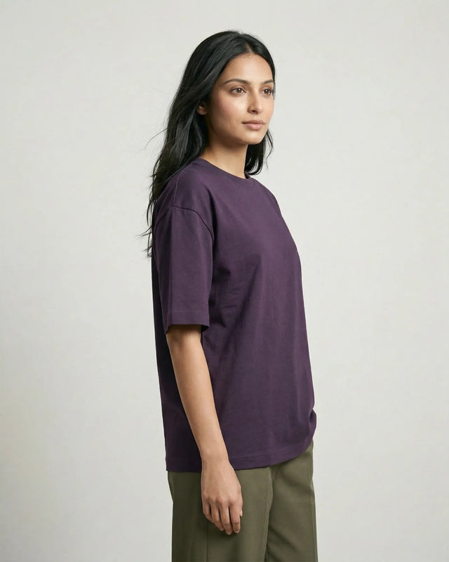 Woman wearing a purple t-shirt against a plain background