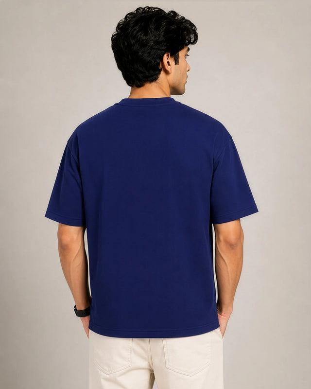 Man wearing a blue t-shirt against a plain background