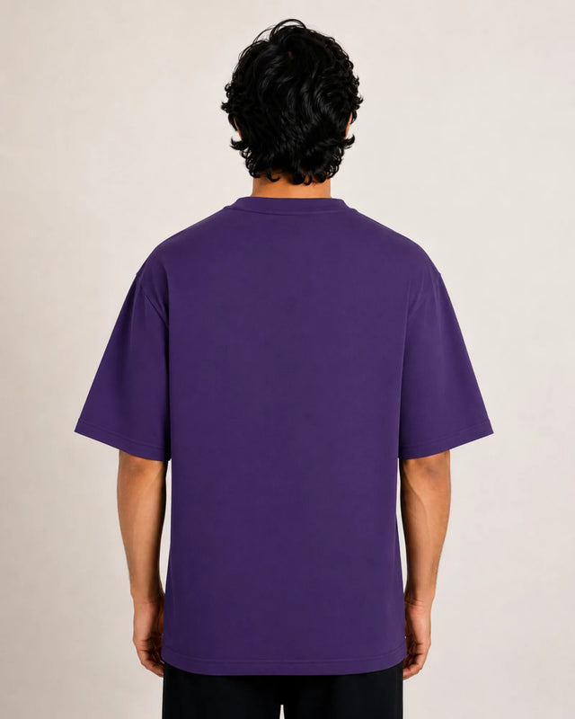 Person wearing a purple t-shirt against a plain background