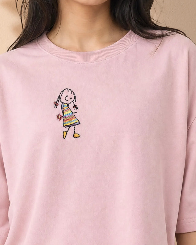 Baby Pink French Terry with a colorful embroidered design of a girl on a beige background