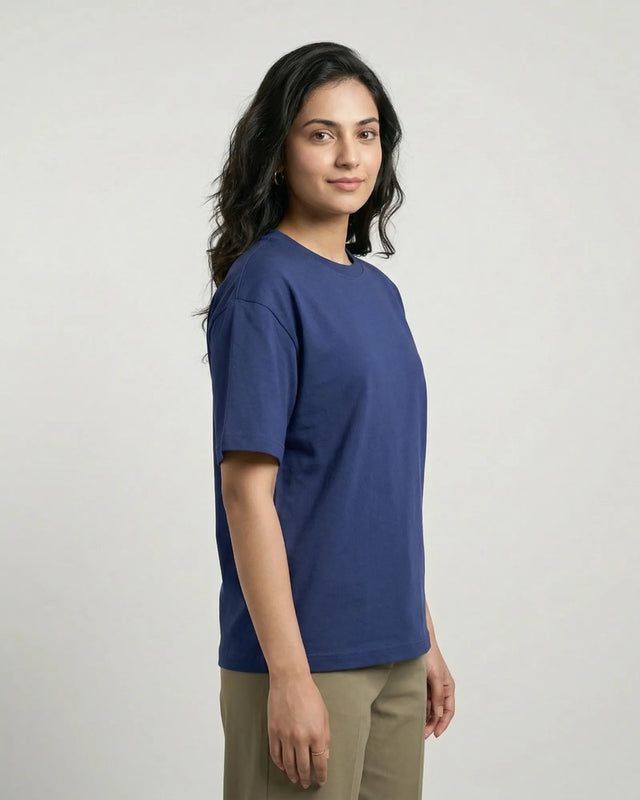 Woman wearing a royal blue t-shirt against a plain background