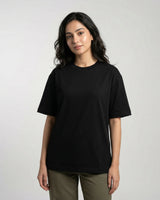 Woman wearing a black t-shirt against a plain background