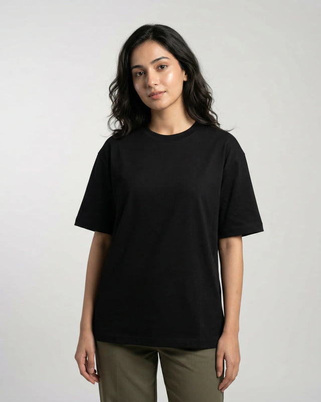 Woman wearing a black t-shirt against a plain background
