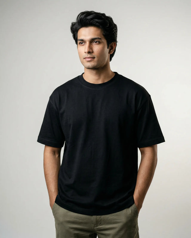 Man wearing a black t-shirt against a plain background
