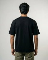 Man wearing a black t-shirt against a plain background