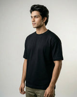 Man wearing a black t-shirt against a plain background