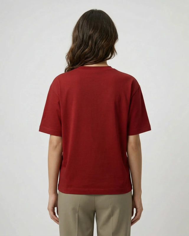 Woman wearing a red t-shirt on a plain background
