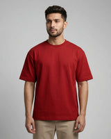 Man wearing a red t-shirt against a gray background