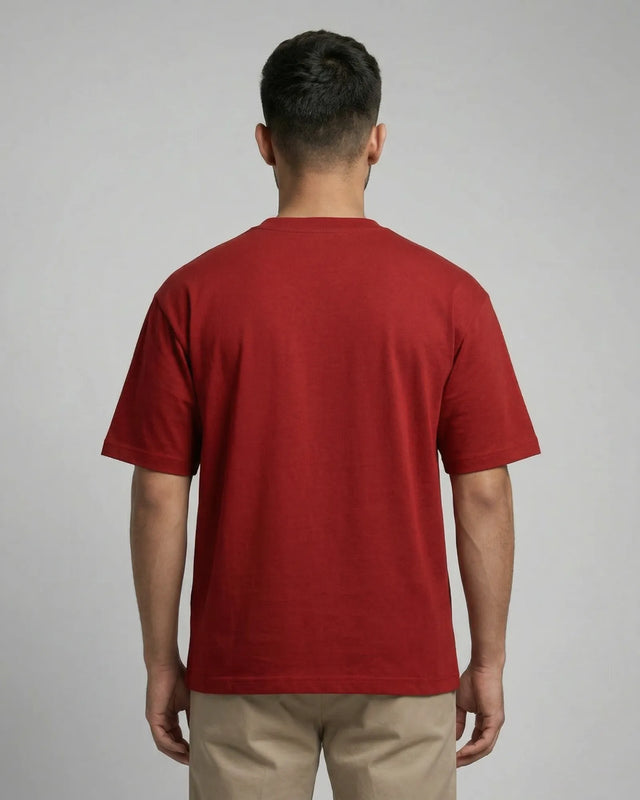 Man wearing a red t-shirt against a gray background