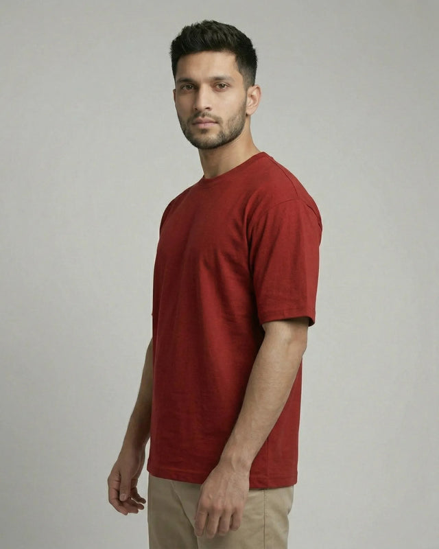 Man wearing a red t-shirt against a plain background
