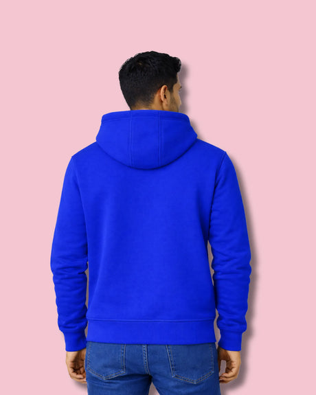 Man wearing a royal blue hoodie on a pink background with back look