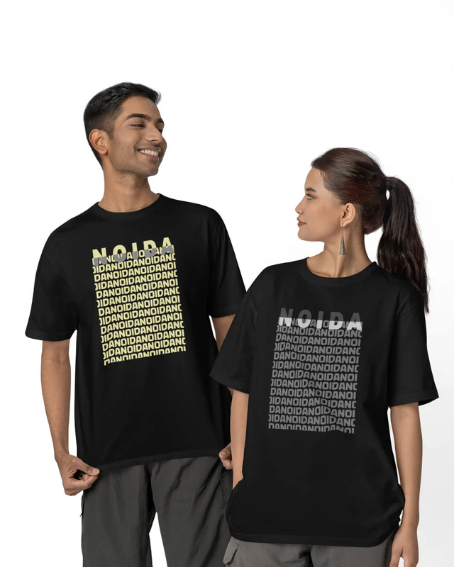 Two people wearing black t-shirts with 'NOIDA' text design.