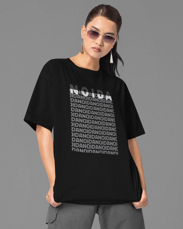 woman wearing a black t-shirt with text design on a gray background