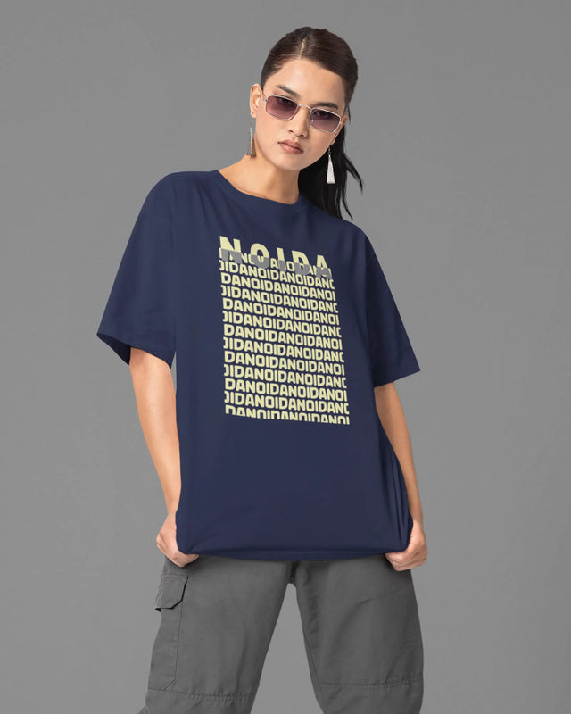 Person wearing a navy blue t-shirt with white text on a gray background