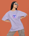 Person wearing a light purple t-shirt with a colorful eye design on an orange background
