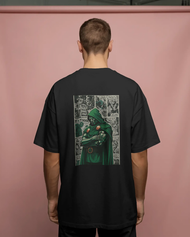 Person wearing a black t-shirt with a green character graphic on the back against a pink background