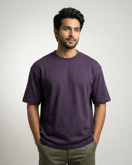 Man wearing a purple t-shirt against a plain background