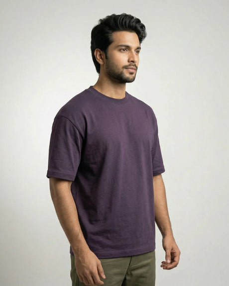 Man wearing a purple t-shirt against a plain background