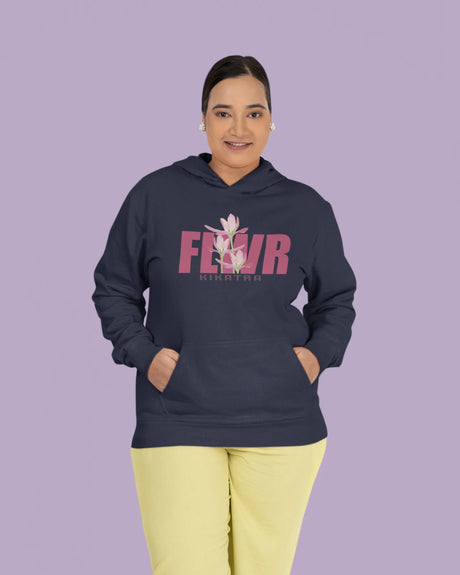 Person wearing a navy hoodie with pink text and floral design on a purple background