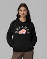 Woman wearing a black hoodie with 'DREAMER' and floral design on a gray background