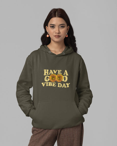 Person wearing a green hoodie with a yellow text design on a gray background