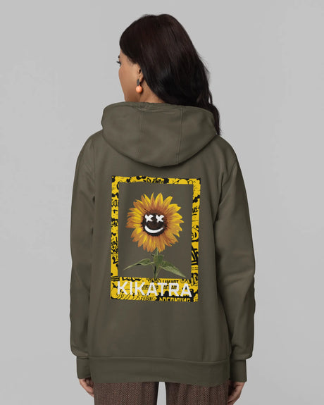 Person wearing a green hoodie with a sunflower design and 'Kikata' text on the back against a gray background