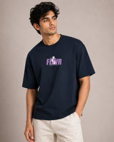 Man wearing a navy blue t-shirt with a logo and text on a beige background