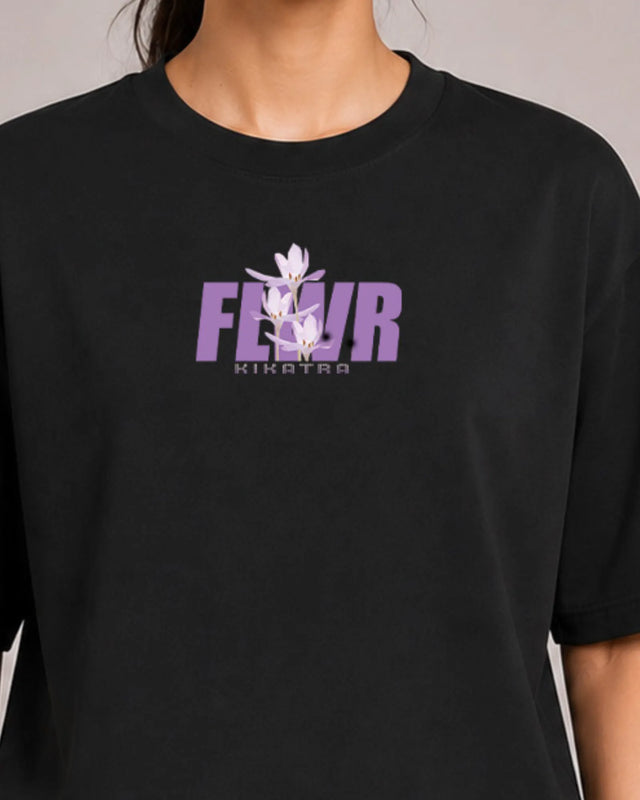 Black t-shirt with purple and white floral design and text on a neutral background