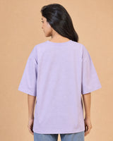 Person wearing a light lavender t-shirt against a beige background