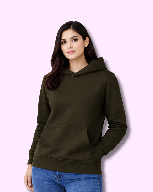 Woman wearing an olive green hoodie on a pink background