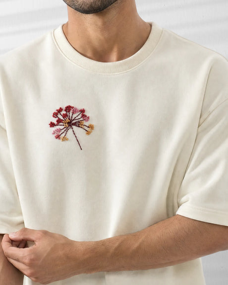 Off-White t-shirt with embroidered flower design on a plain background