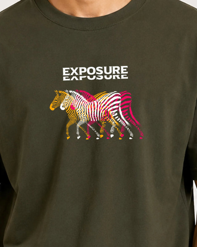 Green t-shirt with colorful zebra design and 'Exposure' text on a plain background