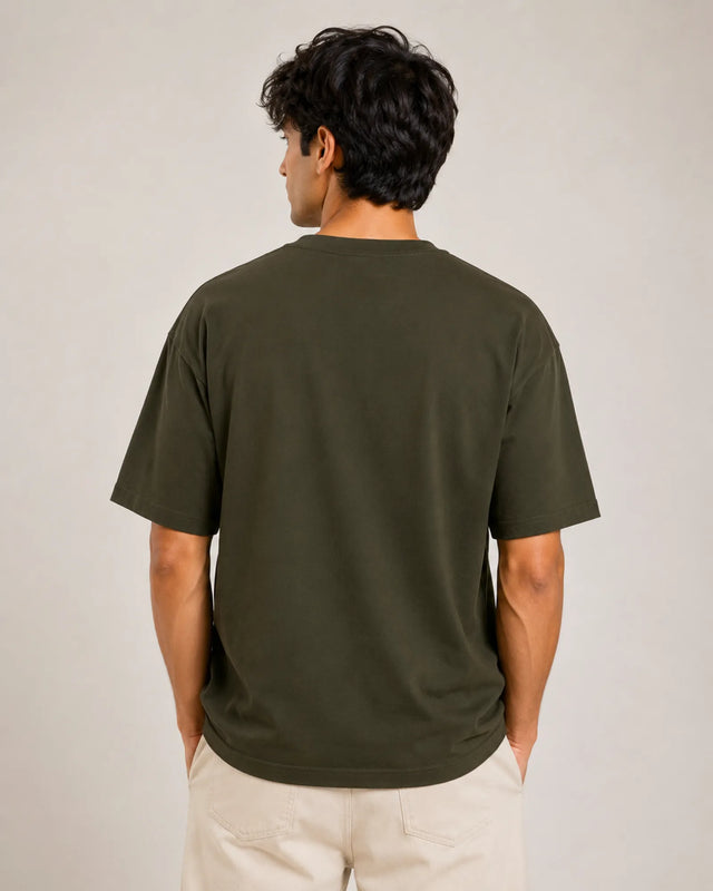 Person wearing a green t-shirt against a plain background
