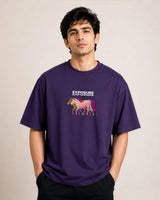 Man wearing a purple t-shirt with a colorful zebra graphic and 'Exposure' text on a beige background