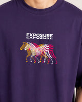 Purple t-shirt with colorful zebra design and 'Exposure' text on a plain background