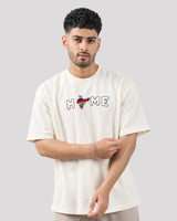 Man wearing a white t-shirt with colorful design and text on a plain background