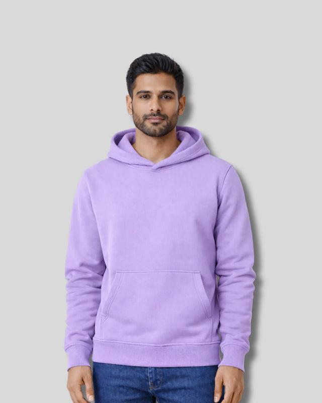 Man wearing a  lavender hoodie against a plain background