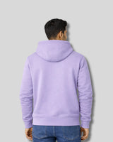 Person wearing a light purple hoodie from behind on a gray background