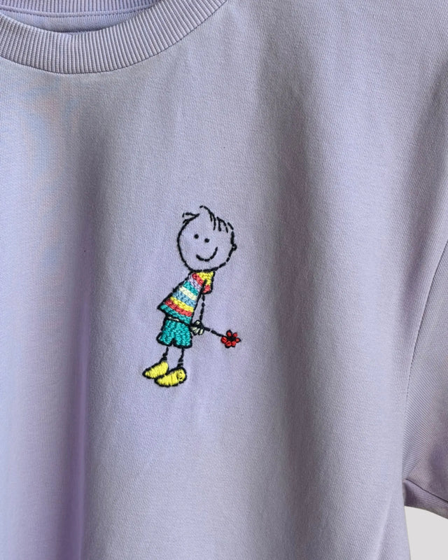 Light Lavender t-shirt with a colorful embroidered design of a stick figure holding a flower.