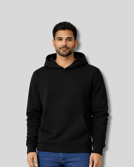 Man wearing a black hoodie against a gray background