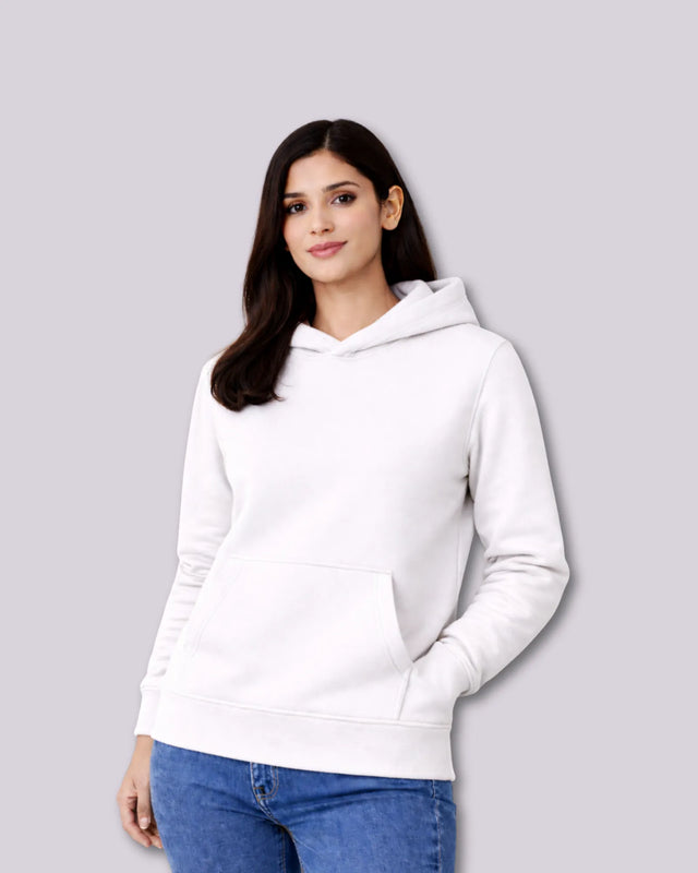 Woman wearing a white hoodie against a gray background